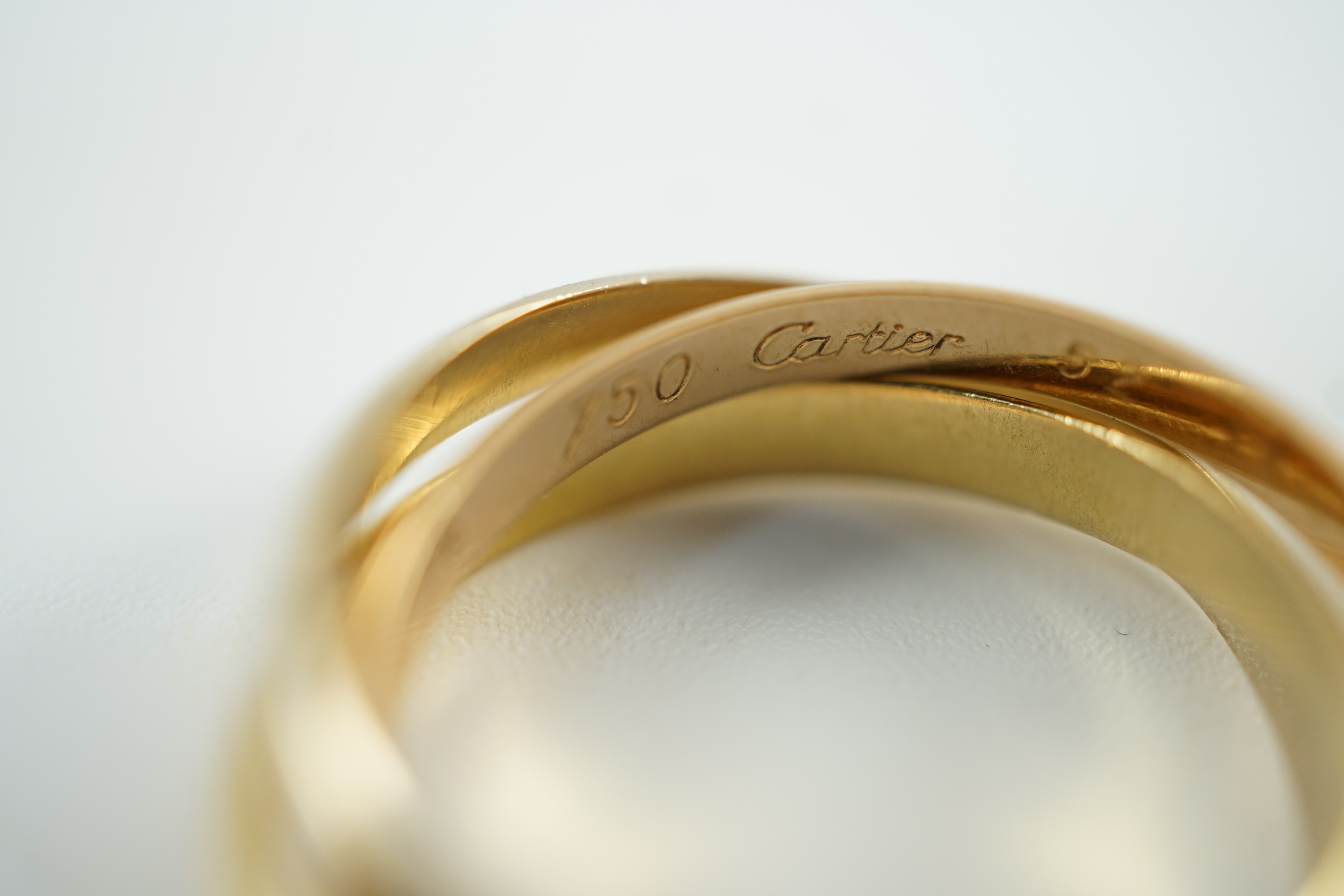 A modern 18ct three colour Cartier 'Russian' triple wedding band